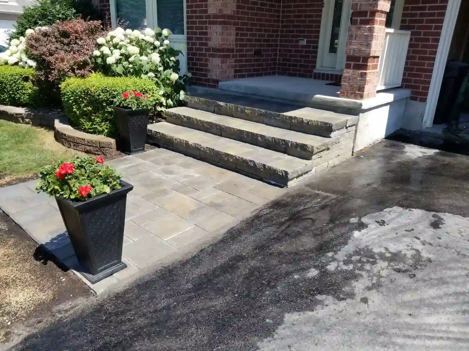 Stone front steps with interlock landing and planter pots